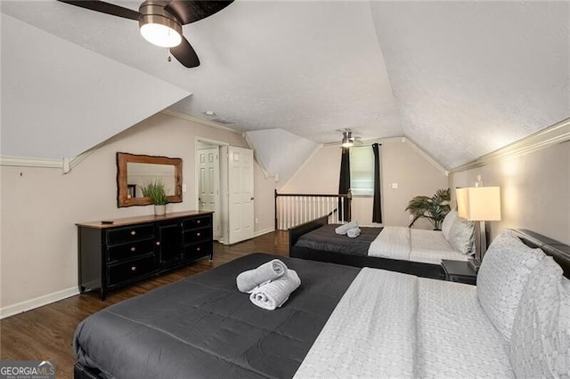 bedroom featuring baseboards, a ceiling fan, ornamental molding, wood finished floors, and vaulted ceiling