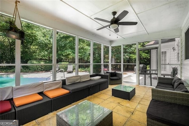 sunroom featuring a ceiling fan and a healthy amount of sunlight