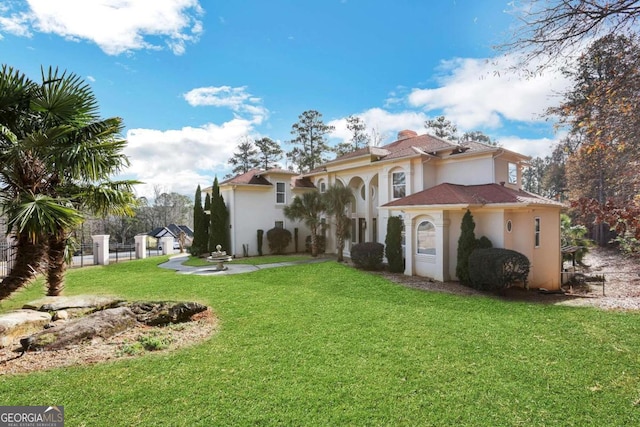 rear view of property with a yard