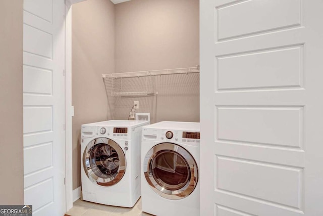 washroom with light tile patterned flooring and independent washer and dryer