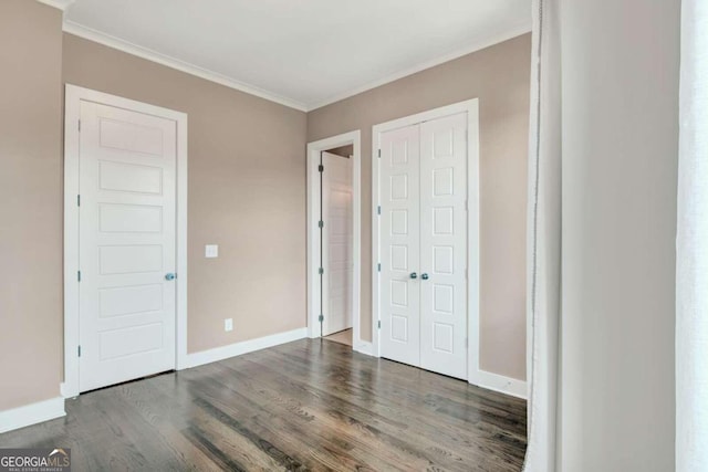 unfurnished bedroom with hardwood / wood-style floors and crown molding