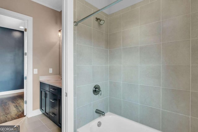 bathroom featuring vanity, tiled shower / bath combo, crown molding, and hardwood / wood-style flooring