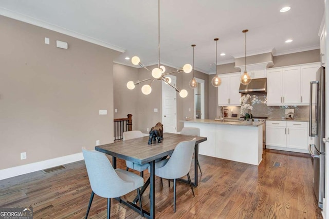 dining space with crown molding and dark wood-type flooring