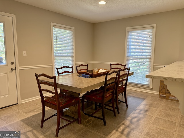 dining area with a textured ceiling