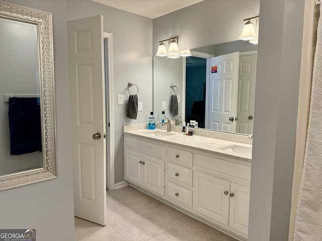 bathroom with vanity and a textured ceiling