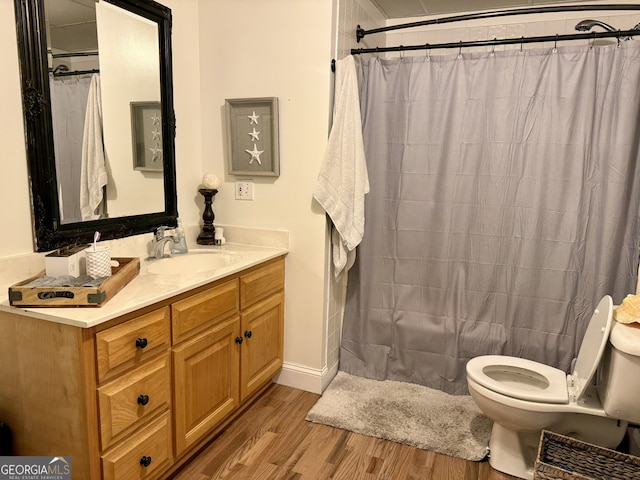 bathroom featuring vanity, a shower with curtain, wood-type flooring, and toilet