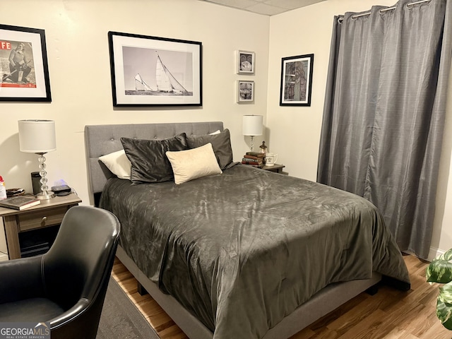 bedroom with hardwood / wood-style flooring