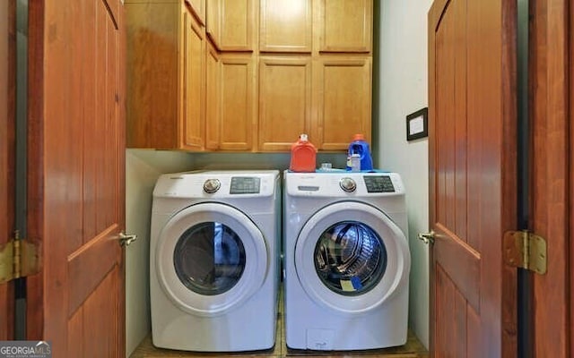 laundry room with cabinets and washing machine and dryer