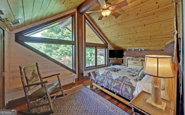 bedroom with ceiling fan, wood walls, wood ceiling, and lofted ceiling