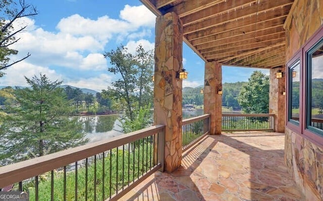 unfurnished sunroom with a water view and a wealth of natural light