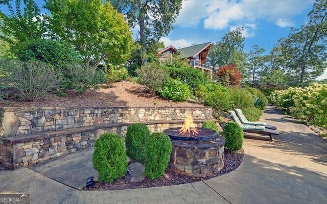 view of patio / terrace featuring an outdoor fire pit