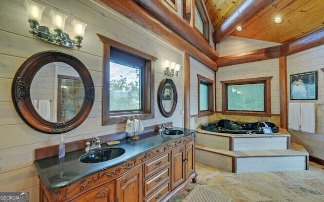 bathroom with a tub, vaulted ceiling with beams, wood walls, vanity, and wood ceiling