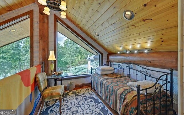 bedroom featuring lofted ceiling and wooden ceiling