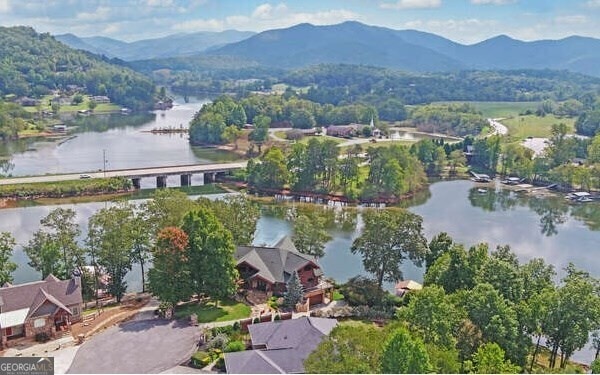 drone / aerial view with a water and mountain view