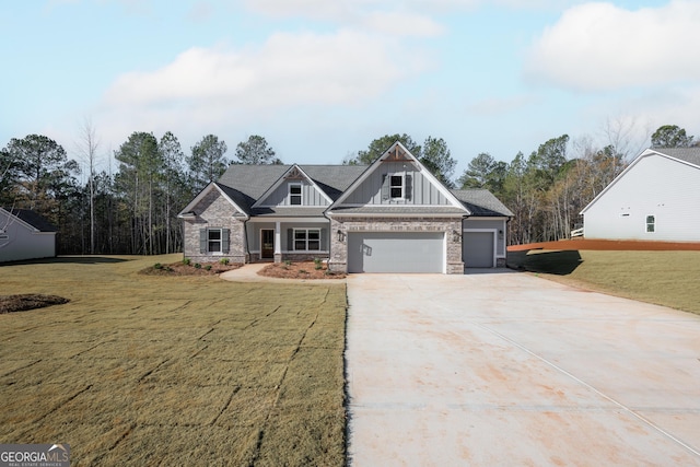 craftsman inspired home with a garage and a front lawn