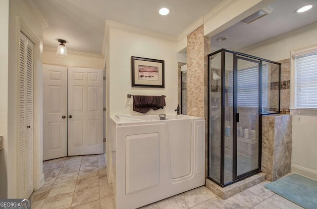 bathroom featuring washer / dryer, an enclosed shower, and crown molding