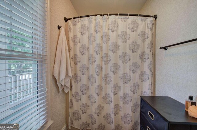 bathroom with a shower with curtain