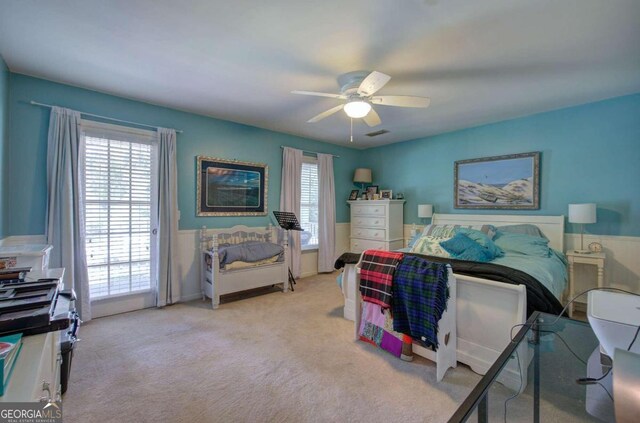 bedroom with light carpet and ceiling fan