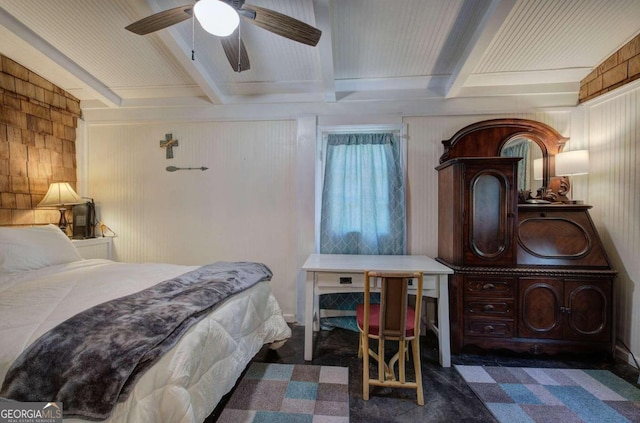 bedroom with dark carpet, beam ceiling, ceiling fan, and wooden walls