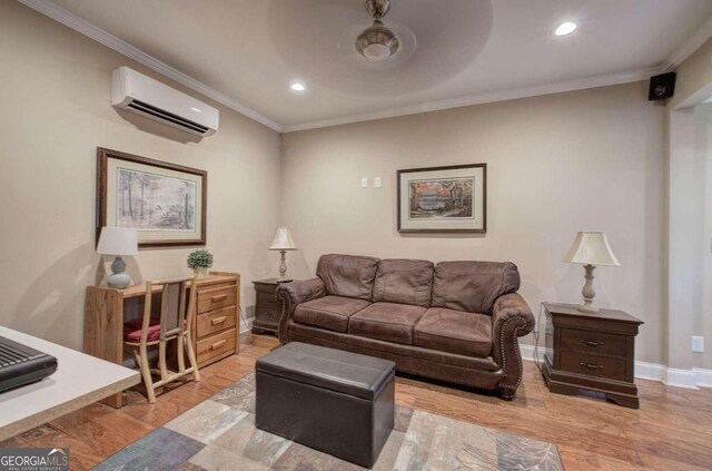 living room with light wood-type flooring, crown molding, a wall unit AC, and ceiling fan