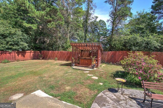 view of yard with a pergola and a patio