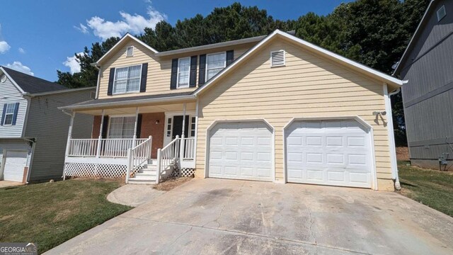 view of front of property featuring a garage and a porch