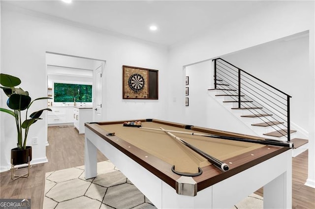 game room with light hardwood / wood-style flooring and pool table