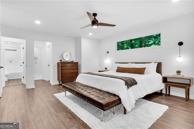 bedroom with ensuite bath, hardwood / wood-style floors, and ceiling fan