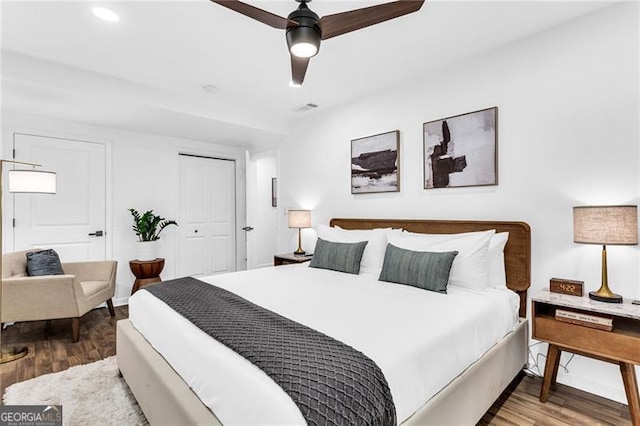 bedroom with ceiling fan, a closet, and wood-type flooring