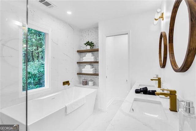 bathroom with a tub to relax in and vanity