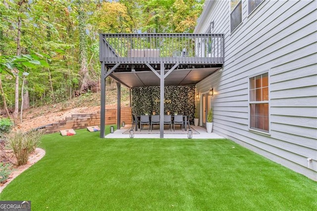 view of yard featuring a patio area and a deck