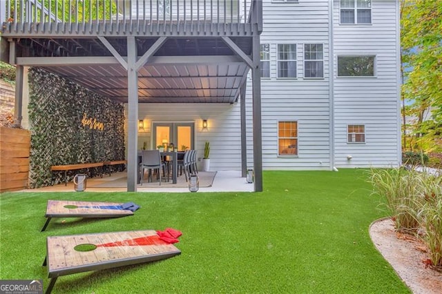 back of house with french doors, a lawn, a patio area, and a deck