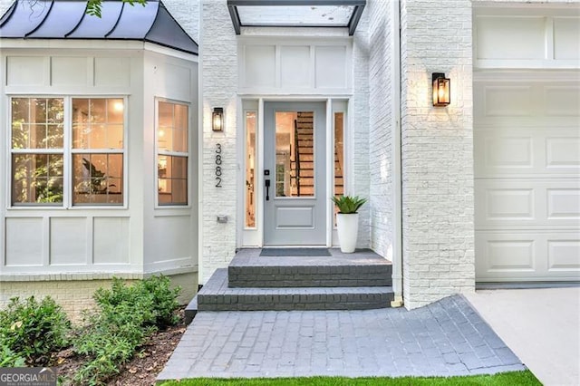 doorway to property with a garage