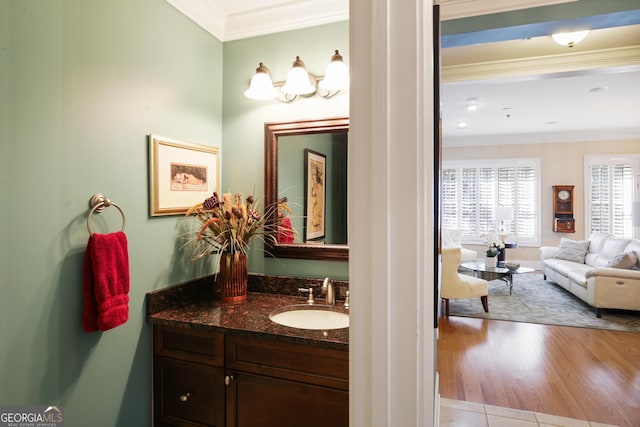 bathroom with ornamental molding, vanity, and hardwood / wood-style flooring