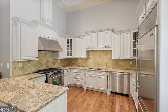 kitchen with light hardwood / wood-style floors, sink, white cabinets, and high quality appliances