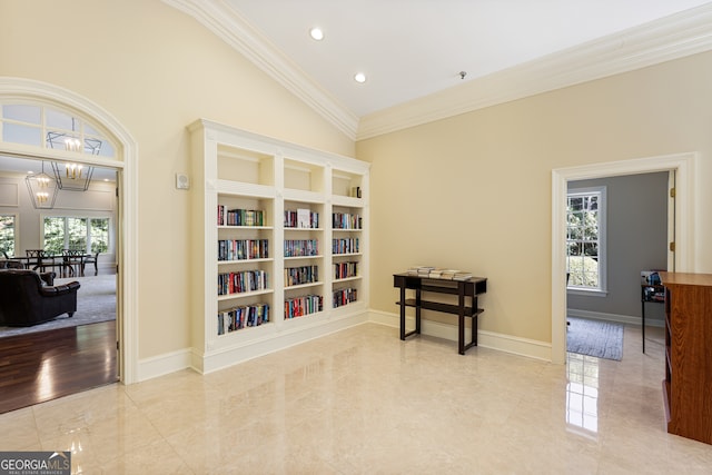 living area featuring lofted ceiling, a notable chandelier, plenty of natural light, and crown molding