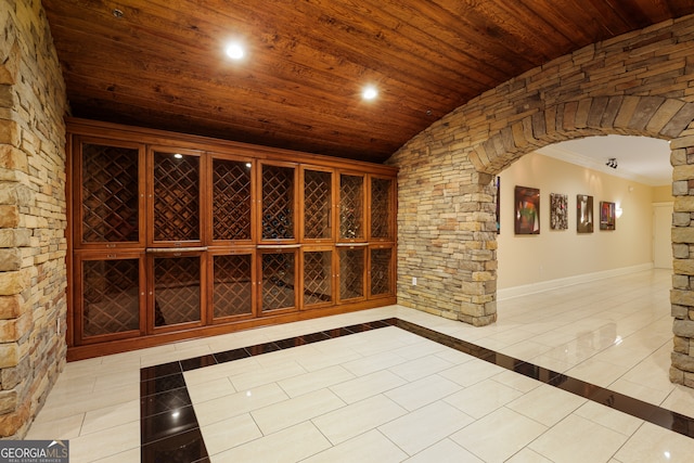 wine cellar featuring wood ceiling, light tile patterned floors, and vaulted ceiling