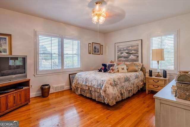 bedroom with light wood-type flooring and ceiling fan