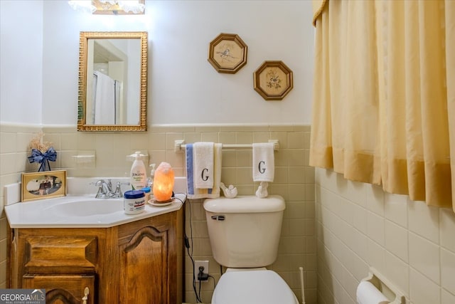 bathroom with tile walls, backsplash, toilet, and vanity