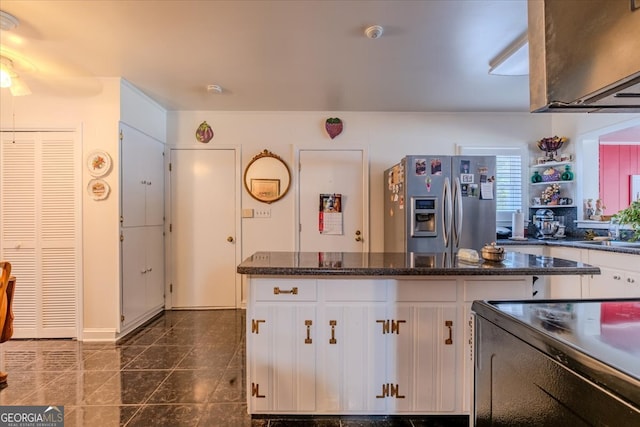 kitchen featuring white cabinetry, dark stone countertops, ceiling fan, and stainless steel fridge with ice dispenser