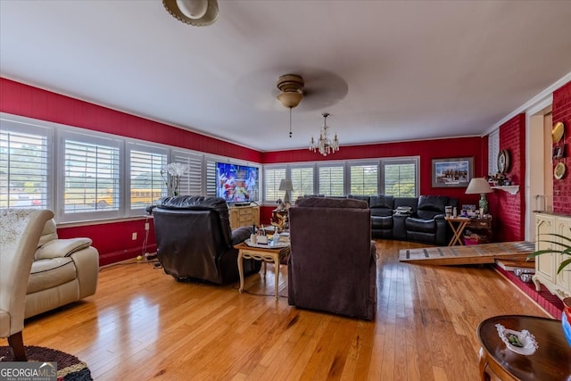 living room featuring ceiling fan, hardwood / wood-style flooring, and ornamental molding