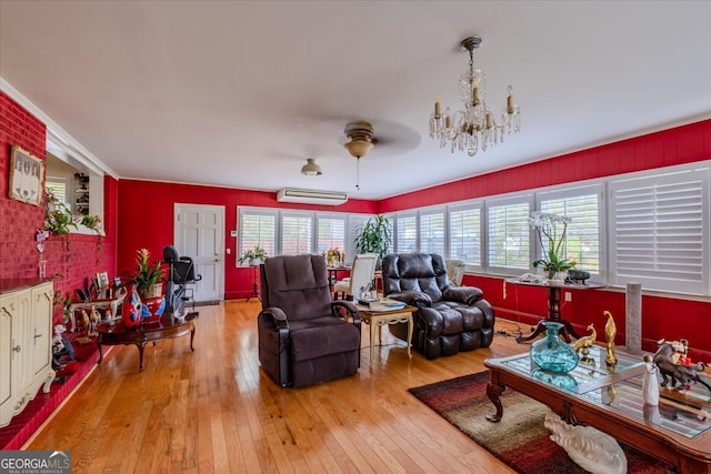 living room featuring ceiling fan, light hardwood / wood-style floors, and an AC wall unit