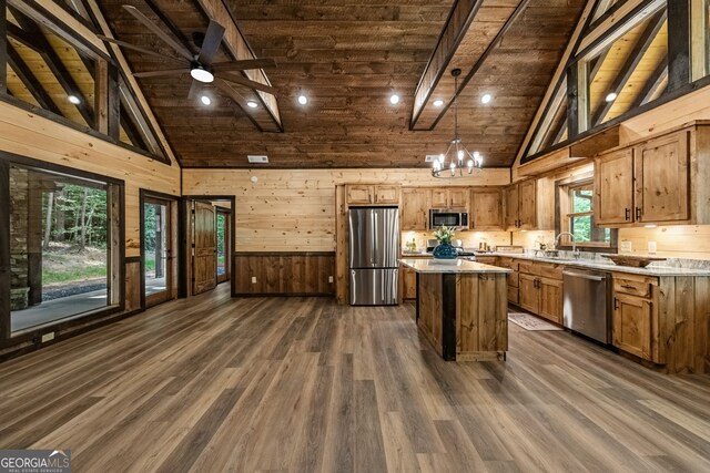 kitchen with a center island, wood ceiling, stainless steel appliances, and dark hardwood / wood-style flooring