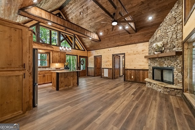 kitchen featuring wooden ceiling, wood walls, ceiling fan, and dark hardwood / wood-style floors