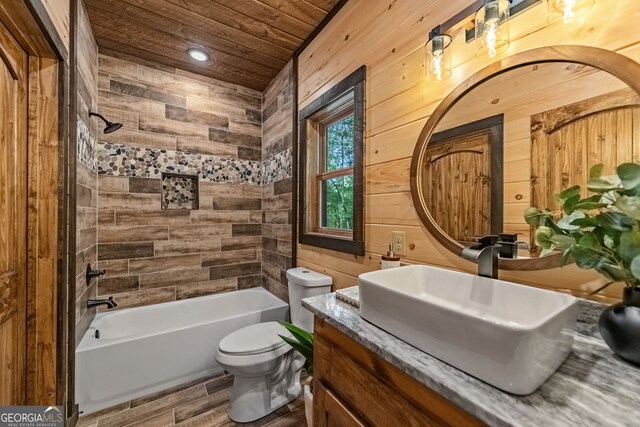 full bathroom featuring tiled shower / bath, wooden ceiling, hardwood / wood-style floors, toilet, and vanity