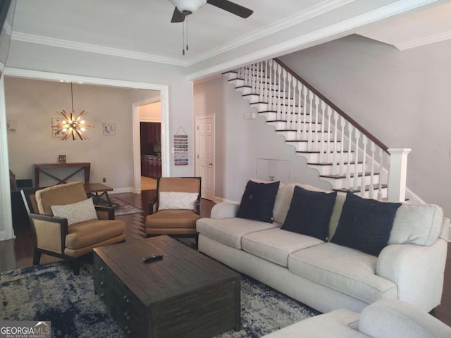 living room with wood-type flooring, ceiling fan with notable chandelier, and ornamental molding