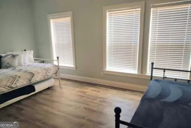 bedroom with hardwood / wood-style flooring