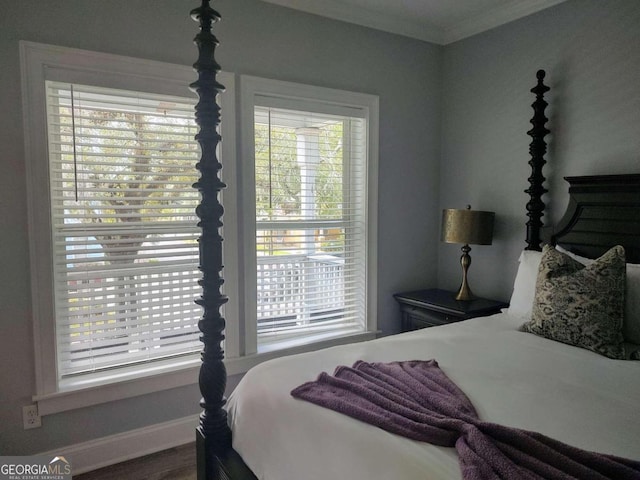 bedroom with multiple windows and crown molding