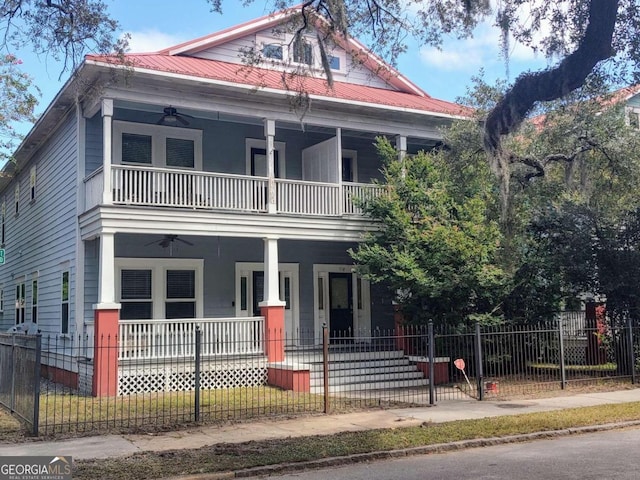 view of front of property with ceiling fan, a balcony, and covered porch