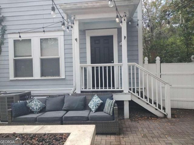 property entrance with central AC unit and an outdoor hangout area